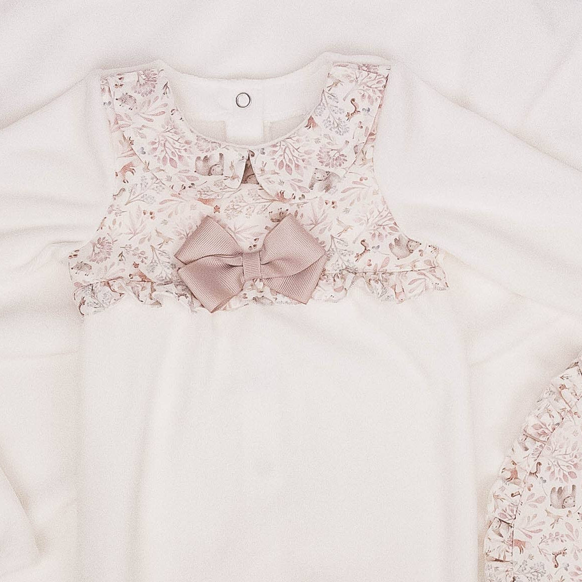 White garment with floral embroidery on a light background