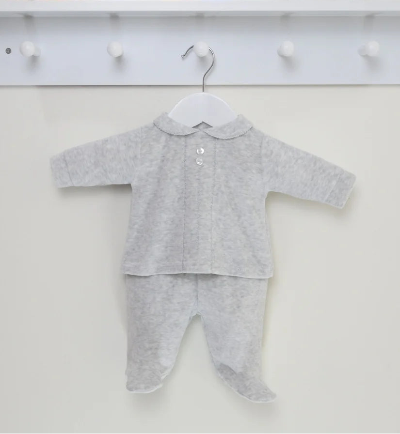 Gray baby outfit on a hanger with toys and alphabet blocks in the background