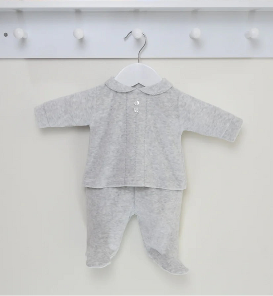 Gray baby outfit on a hanger with toys and alphabet blocks in the background